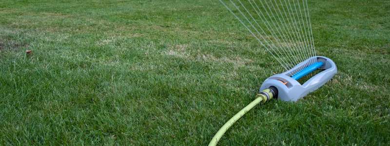 Sprinker spraying water on lawn with dry streaks